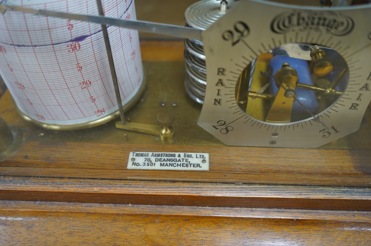 An oak cased barograph with integral barometer by Thomas Armstrong & Bro. Ltd. 78 Deansgate, Manchester, with bevelled glass panels and drawer to base, 37cm wide, 23cm deep, 22cm high. Condition - good, untested.